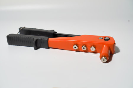 Orange And Black Manual Riveter Tool On White Backgroundの写真素材