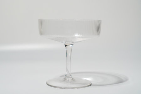 Clear Ribbed Coupe Glass On White Backgroundの写真素材