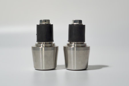 Pair Of Stainless Steel Cylindrical End Caps With Black Rubber Grommetsの写真素材