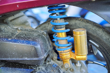 Close up View Of A Dusty Motorcycle Shock Absorber With Blue And Gold Springsの写真素材