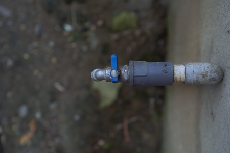 Close Up Of A Weathered Gray And Blue Metal Water Faucet Outdoorsの写真素材