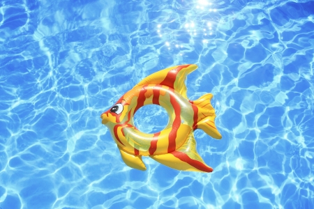 Fish shaped lifebuoy on swimming poolの写真素材