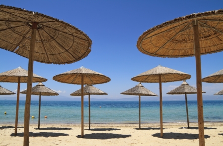 Umbrellas by the sea on exotic resort, Thassos island - Greeceの写真素材