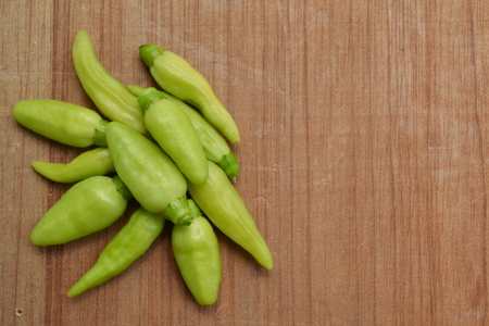 Fresh green chilli on wooden background. Ready to cookの写真素材