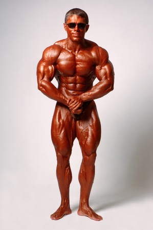 Muscled male model posing in studio on a light backgroundの写真素材