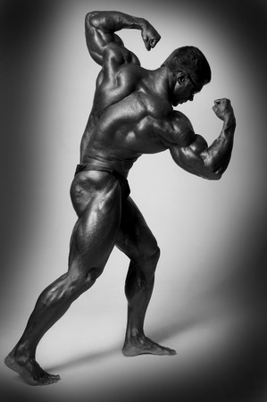Muscled male model posing in studio on a light backgroundの写真素材