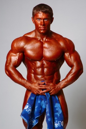 strong athletic man with a towel in handsの写真素材