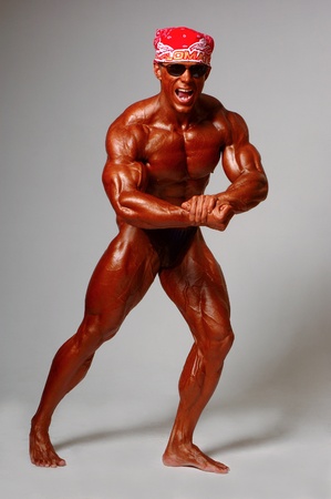 Muscled male model posing in studio on a light backgroundの写真素材