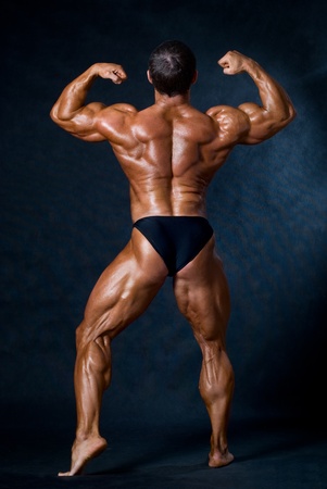Muscled male model posing in studioの写真素材