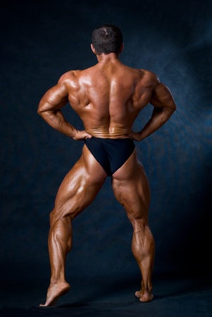 Muscled male model posing in studioの写真素材