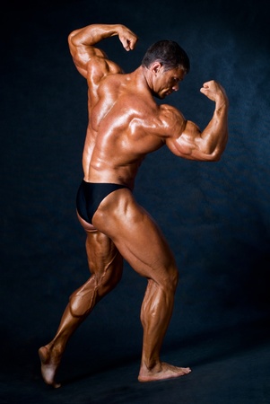 Muscled male model posing in studioの写真素材