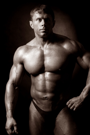Muscled male model posing in studioの写真素材
