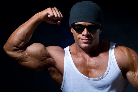 Handsome muscular man on a black backgroundの写真素材