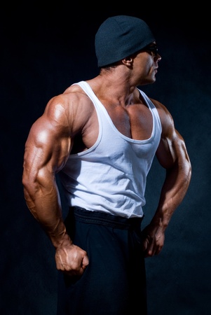 strong athletic man in dark glasses on a black backgroundの写真素材
