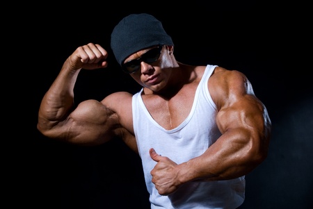 Handsome muscular man on a black backgroundの写真素材