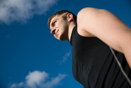 Portrait of the sportsman against the skyの写真素材