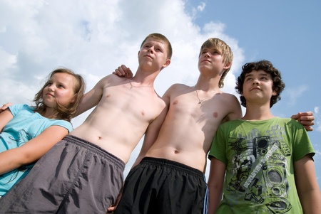 Command from four children look aside against the skyの写真素材