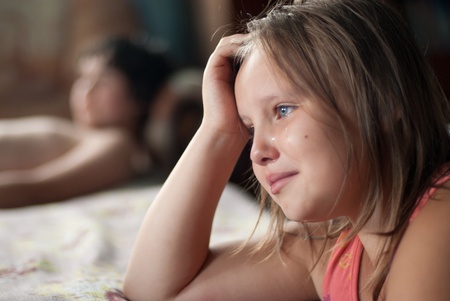 The girl watches film and criesの写真素材