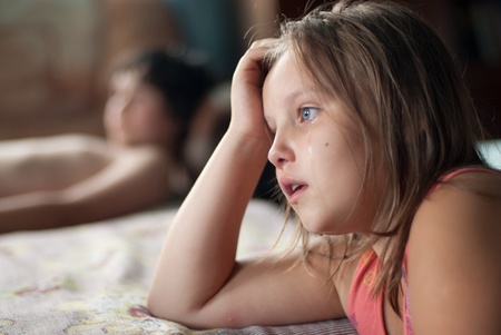 The girl watches film and criesの写真素材