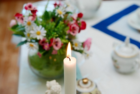 Burning candle on a festive tableの写真素材