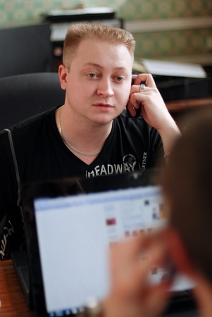 The beautiful person working with laptop and calling by cellularの写真素材
