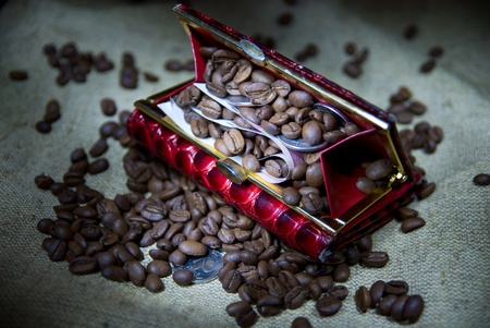 Coffee grains and money in a red purseの写真素材