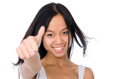 Pretty young woman showing thumb up, isolated on white backgroundの写真素材