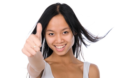 Pretty young woman showing thumb up, isolated on white backgroundの写真素材