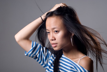 teen girl beautiful cheerful enjoying isolated on gray backgroundの写真素材