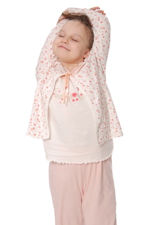 The girl stretches in a sleeping pajamas isolated on white backgroundの写真素材