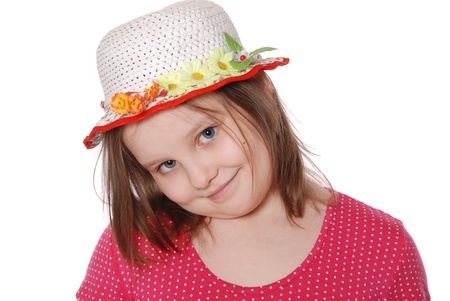 Portrait of little girl wearing a hat ans smiling isolated on white backgroundの写真素材