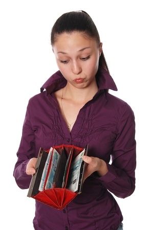 The surprised beautiful girl looks at money in a purse,verticalの写真素材