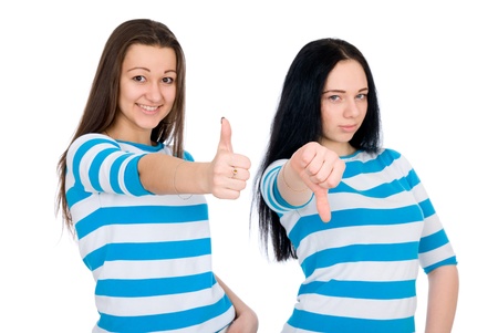Two attractive girls show thumbs isolated on white backgroundの写真素材