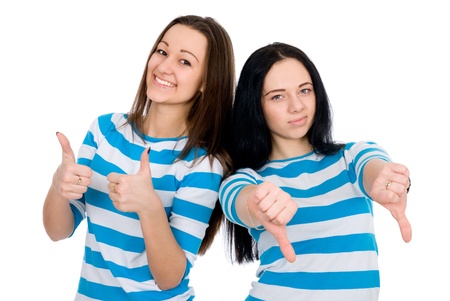 Two attractive girls show thumbs isolated on white backgroundの写真素材