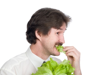 Man eats sheet of the salad. Isolated on white backgroundの写真素材