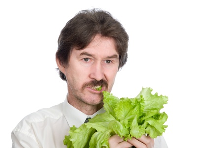 Man eats sheet of the salad. Isolated on white backgroundの写真素材