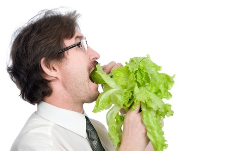 Man eats sheet of the salad. Isolated on white backgroundの写真素材