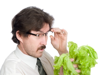 Man with surprise looks at sheet of the salad. Isolated on white backgroundの写真素材