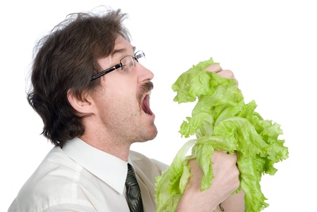 Man eats sheet of the salad. Isolated on white backgroundの写真素材