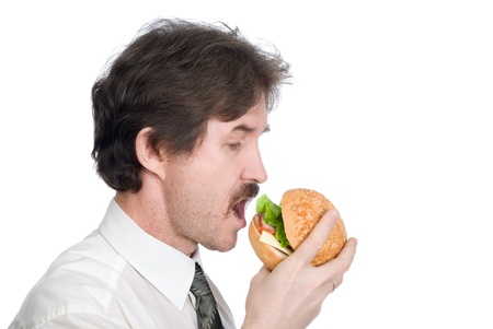 Man with moustache eats hamburger. Isolated on white backgroundの写真素材
