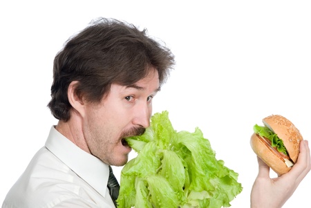Man prefers salad instead of hamburger. Isolated on white backgroundの写真素材