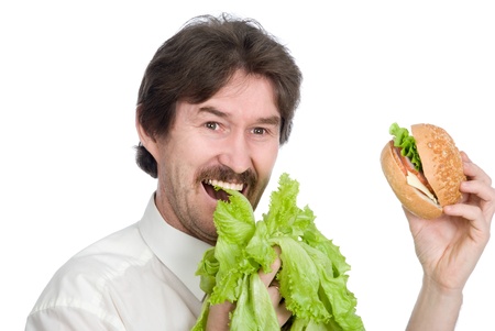 Man prefers salad instead of hamburger. Isolated on white backgroundの写真素材