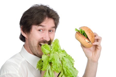 Man prefers salad instead of hamburger. Isolated on white backgroundの写真素材