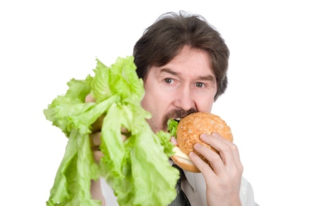 Man prefers hamburger instead of salad. Isolated on white backgroundの写真素材