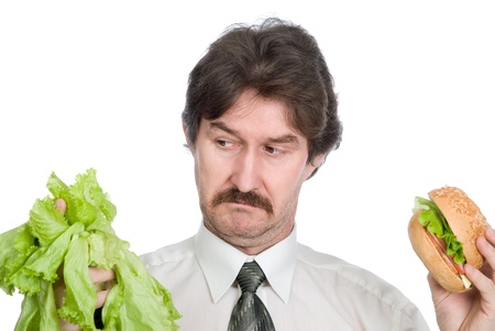 Choice of the businessman-salad or hamburger. Isolated on white backgroundの写真素材