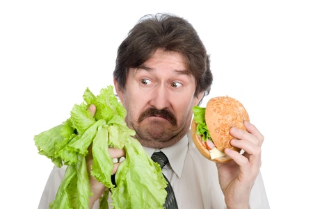 Choice of the businessman-salad or hamburger. Isolated on white backgroundの写真素材