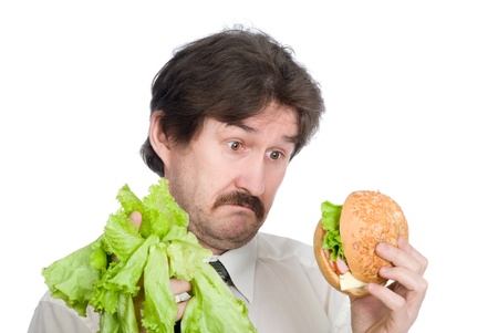 Choice of the businessman-salad or hamburger. Isolated on white backgroundの写真素材