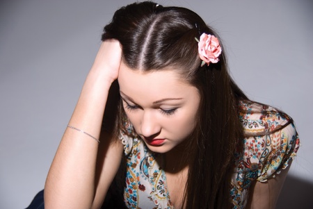 Portrait of the beautiful girl with a flower on a headの写真素材