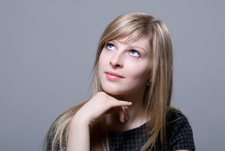 Portrait of the beautiful blonde looking off in thought - expression series - thinkingの写真素材