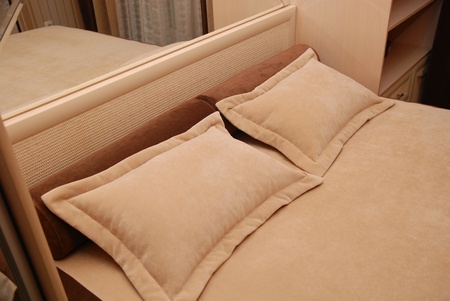 pillows on a bed in a bedroomの写真素材